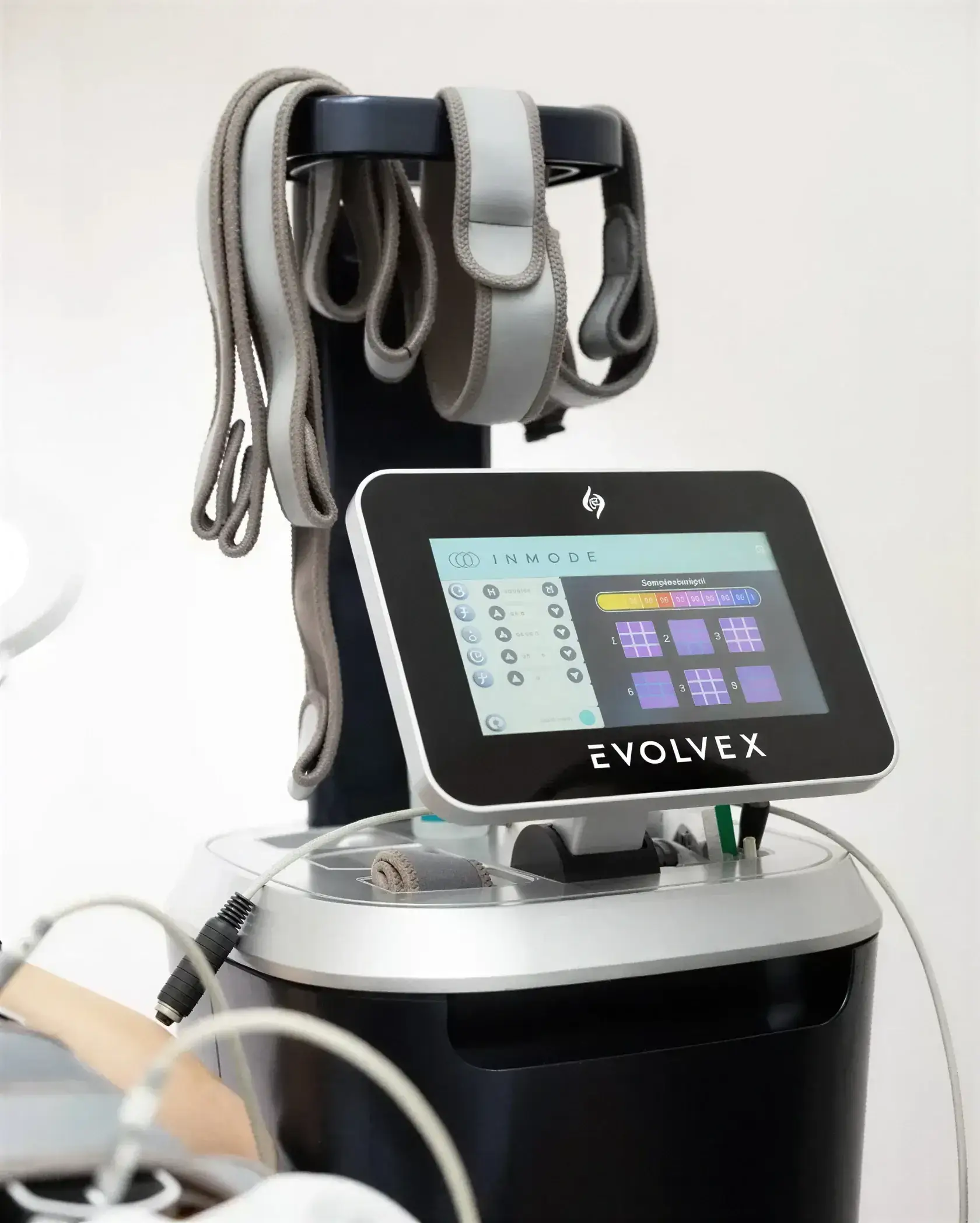 The EvolveX by InMode console and its applicators, displaying live temperature and muscle-stimulation settings