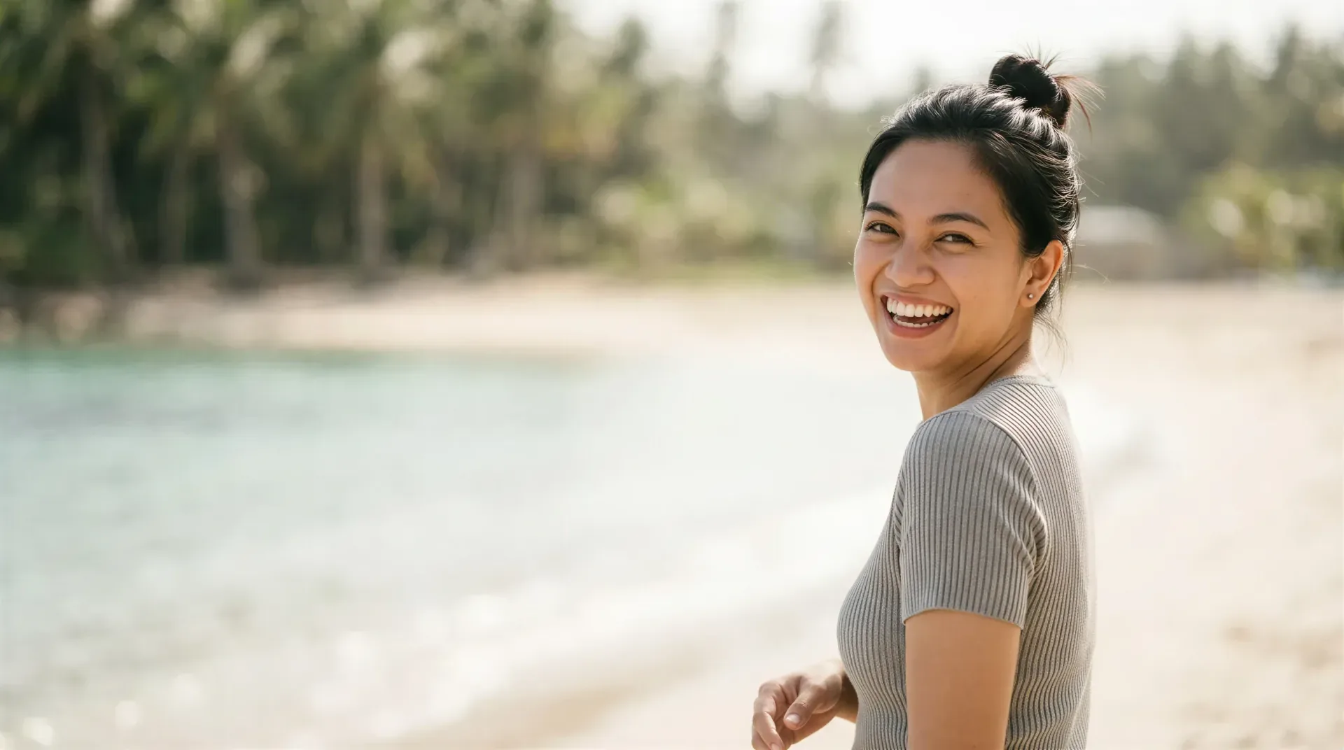 Smiling woman outdoors in soft sunlight with a hydrated, glowing complexion, evoking the HydraFacial glow in Dallas