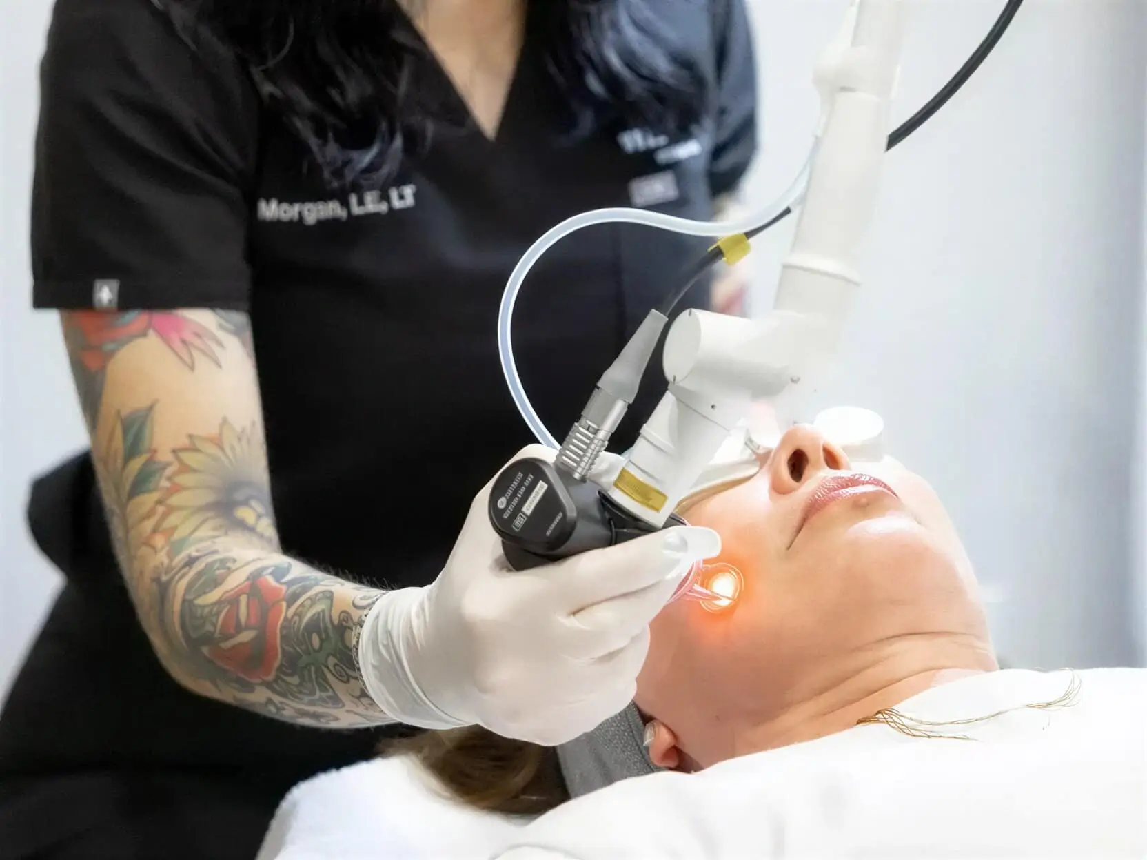 A Well Labs+ provider treating a client's face with the Hollywood Spectra laser