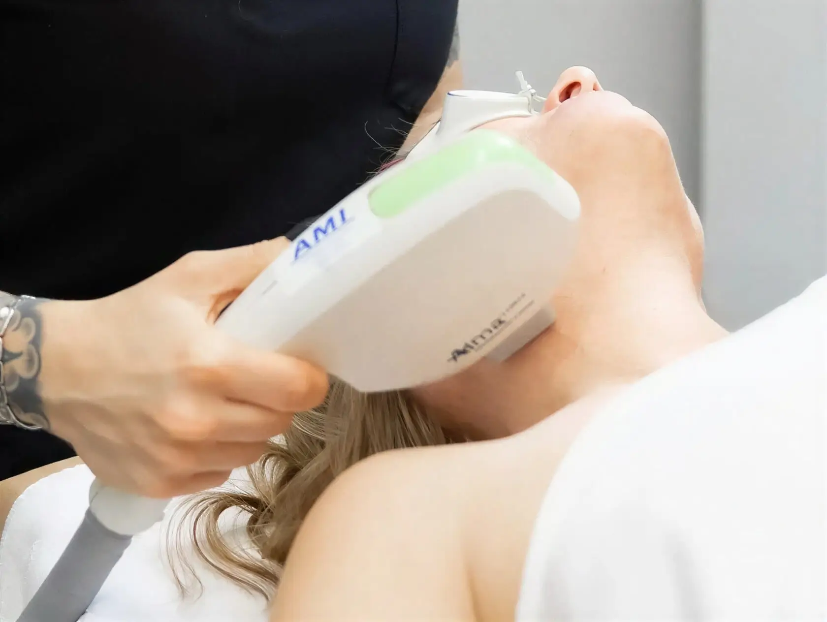 A Well Labs+ provider performing an IPL photofacial on a client's face with an Alma handpiece