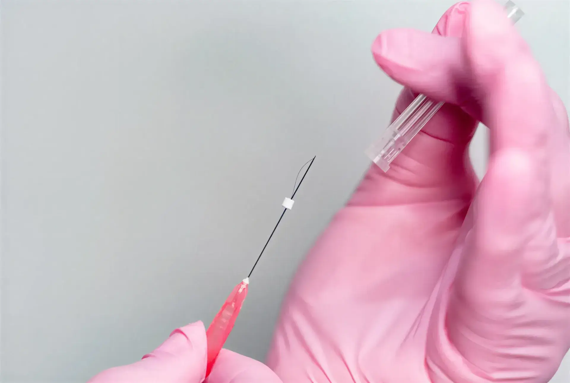 A gloved provider preparing a fine PDO thread cannula