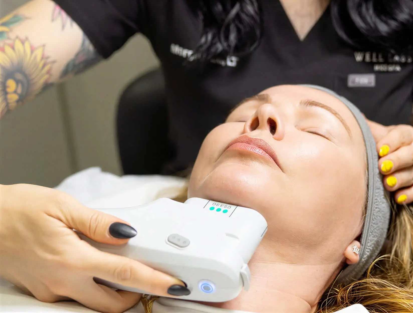 A Well Labs+ provider treating a client's jawline and neck with the Ultherapy handpiece