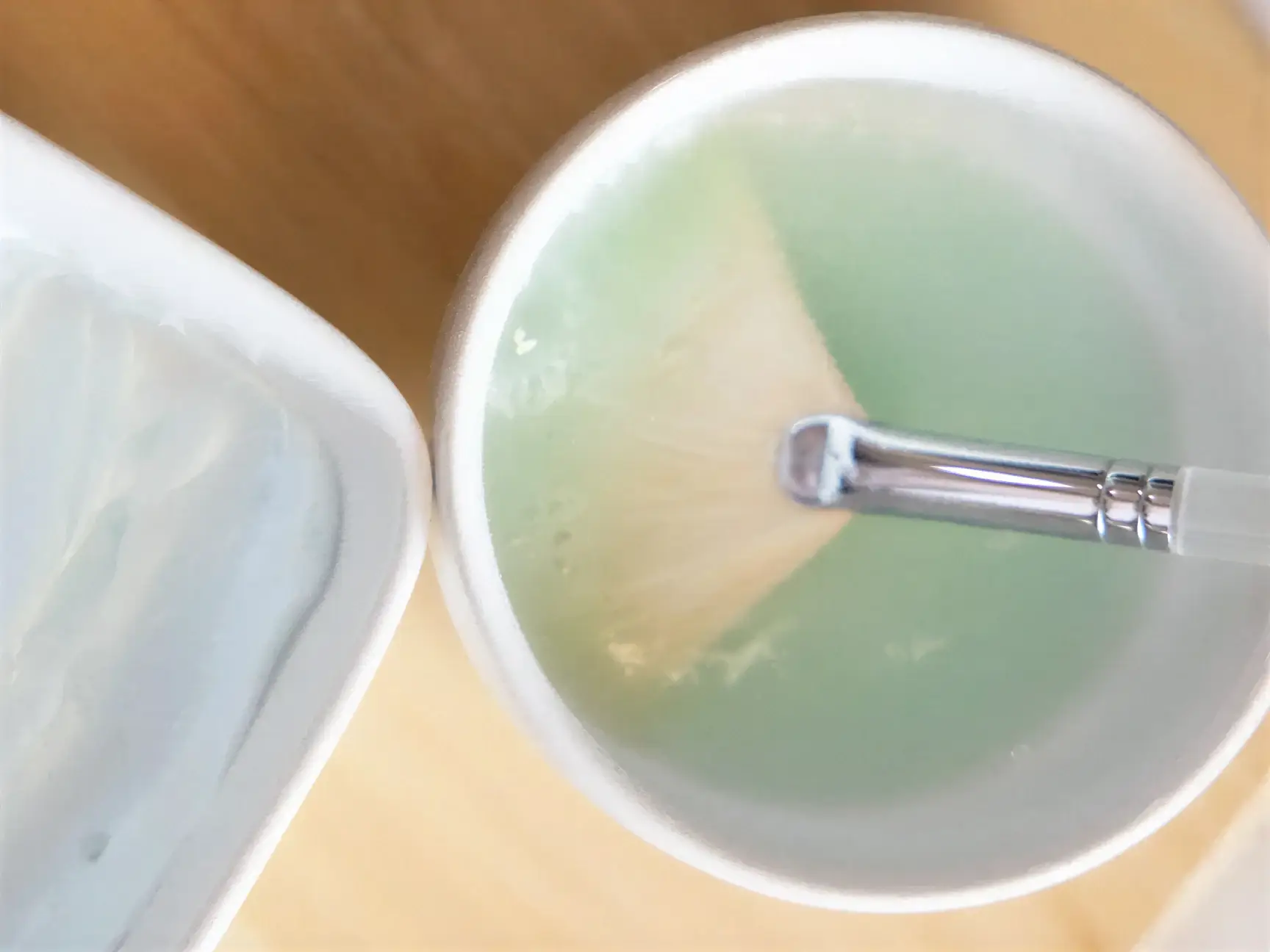A medical-grade peel solution being measured and mixed with an applicator brush in preparation for a Well Labs+ facial treatment