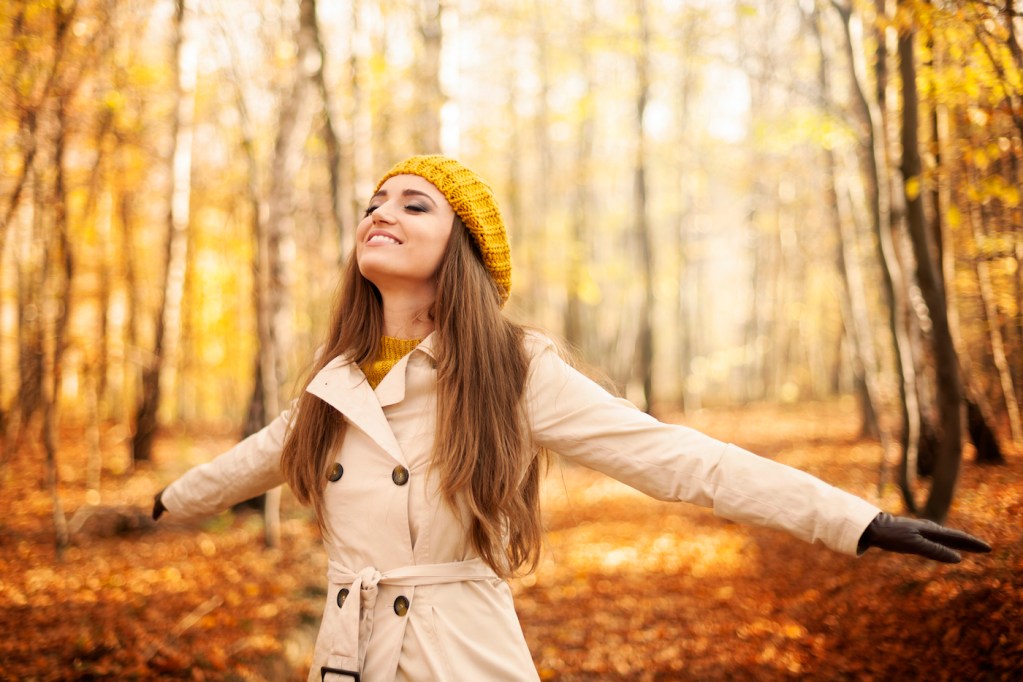 Young woman enjoying nature at autumn