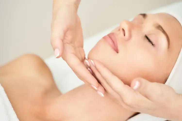 Close-up of a woman’s face receiving a rejuvenating facial massage with gentle techniques.